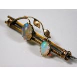 A yellow metal bar brooch set with two opals 3.9g