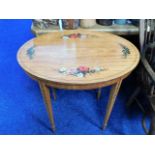 A Regency style satinwood oval hall table with decorative motifs