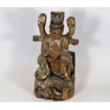 A Chinese polychrome carved wood figure depicting