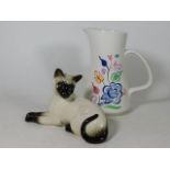 A Beswick Siamese cat twinned with a Poole pottery