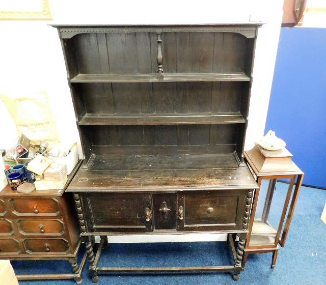 An early 20thC. oak dresser with barley twist legs