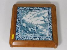 A large decorative mounted tile featuring dog & wi