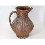 An antique woven wicker water jug, possibly North