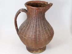 An antique woven wicker water jug, possibly North