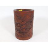 A Chinese bamboo brush pot with carved decor 5.75i