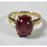 A 9ct gold ring with approx. 7ct star ruby & two small diamonds on shoulders 4.2g size N/O