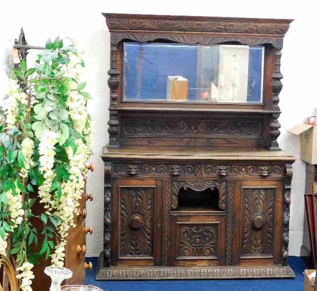 A large 19thC. mirror backed gothic style oak dres