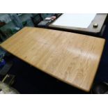 An Ercol extending light elm table 79.5in x 36.5in