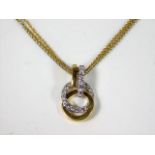 An 18ct two tone gold & diamond pendant with 18ct