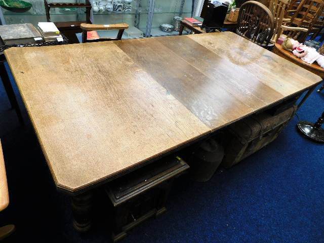 A large 19thC. oak extending table with fluted leg