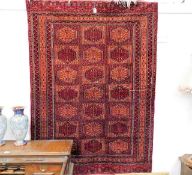 A Persian Bokhara style carpet 71in x 50in