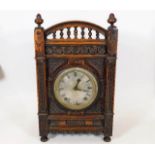 An oak cased A. Reiss chiming mantel clock