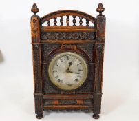 An oak cased A. Reiss chiming mantel clock