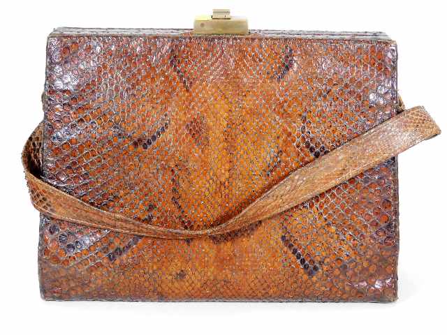 An early 20thC. snakeskin bag with brass fittings