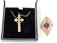 A silver cross set with small ruby twinned with a
