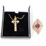 A silver cross set with small ruby twinned with a