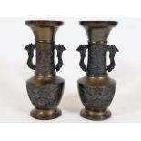 A pair of Japanese bronze vases with dragon decor