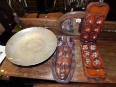 A brass bowl with stand twined with an ethnic mask