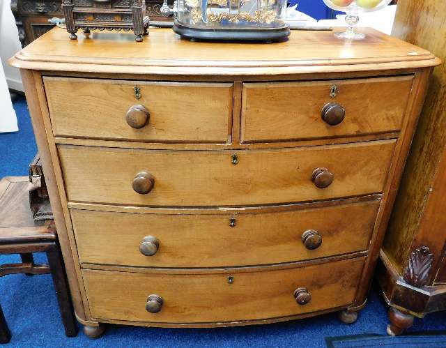 A Victorian bow fronted chest of drawers, some fau