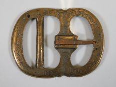 A bronze buckle indistinctly inscribed Pok Grimsso