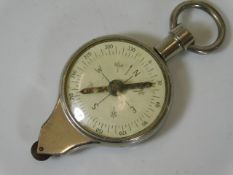 A pocket size compass & map gauge
