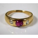 A yellow metal gypsy ring, tests at 18ct, set with 0.5ct of diamond & a central ruby 5.5g size M/N