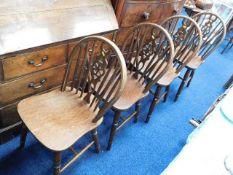 A set of four wheel back farmhouse style chairs