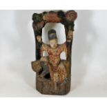 A Chinese polychrome carved wood figure depicting