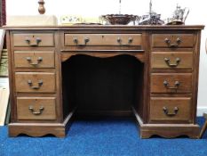 A kneehole desk with brass fittings, some faults