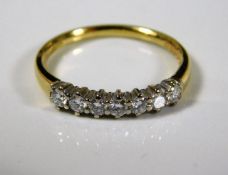 An 18ct gold ring set with seven diamonds 2.4g siz