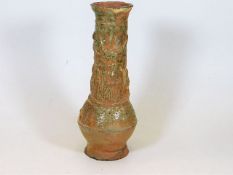 A Chinese earthenware part glazed vase depicting d