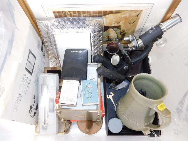 A St. Ives marked pottery tankard, chipped to base of handle, a modern microscope, a glass photo fra