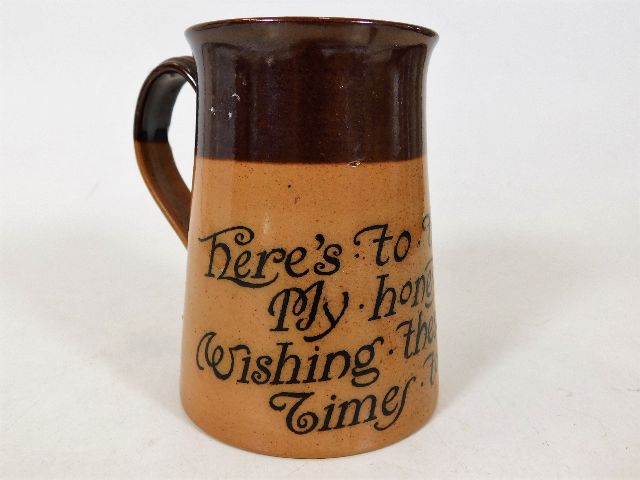 A Doulton stoneware tankard with motto: Here's to