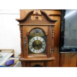 A compact brass faced longcase clock