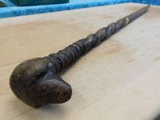 A walking cane with carved dog head