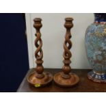 A pair of barley twist oak candlesticks