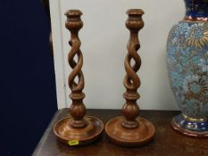 A pair of barley twist oak candlesticks