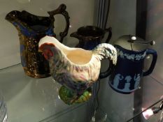 Two copper lustre jugs, a pottery chicken jug & a