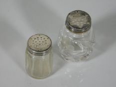 Two small silver topped picnic pepper pots