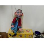 A Pelham puppet figure with box