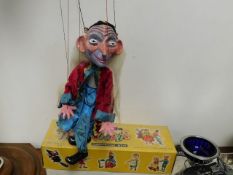 A Pelham puppet figure with box