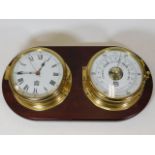 A modern mounted brass ships style clock with baro