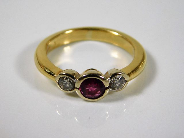 A yellow metal ring, tests at 18ct gold, set with