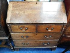 A George III oak bureau, some faults