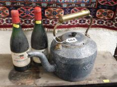 A cast iron Holcroft kettle twinned with two bottl