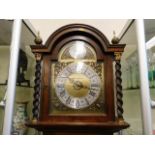 A longcase clock with brass & silver colour dial