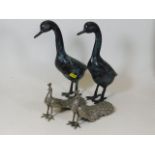 A pair of decorative bronzed geese twinned with tw