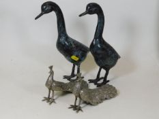 A pair of decorative bronzed geese twinned with tw