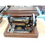 A Victorian Singer sewing machine with case