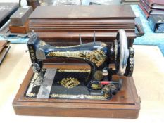 A Victorian Singer sewing machine with case